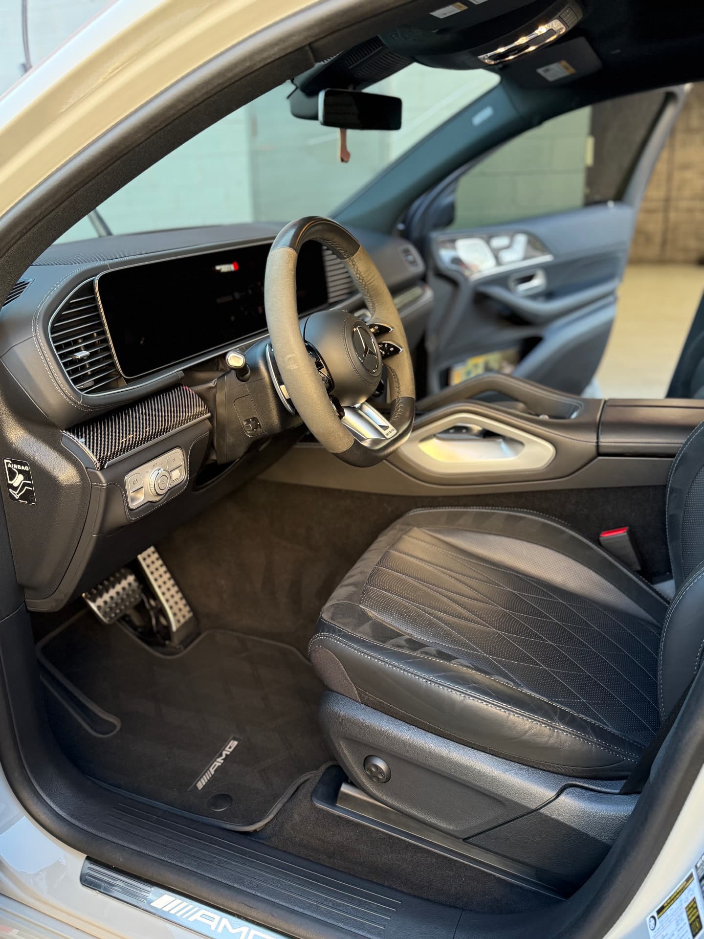 Detailed Mercedes-AMG cockpit with clean quilted leather seats, dashboard and floor mats